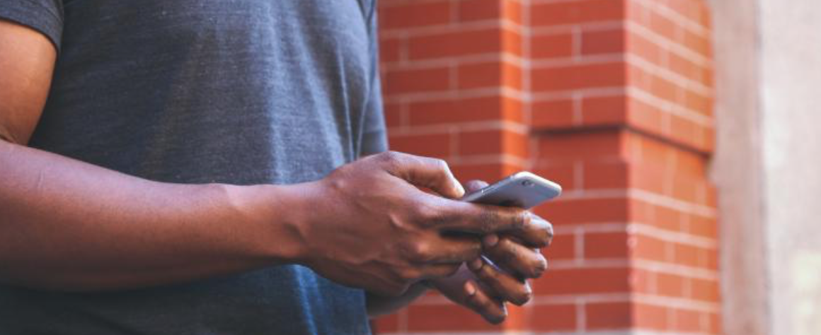 Man using his phone. With remarketing, you can continue to reach your target audience after a geo-fencing campaign has ended.