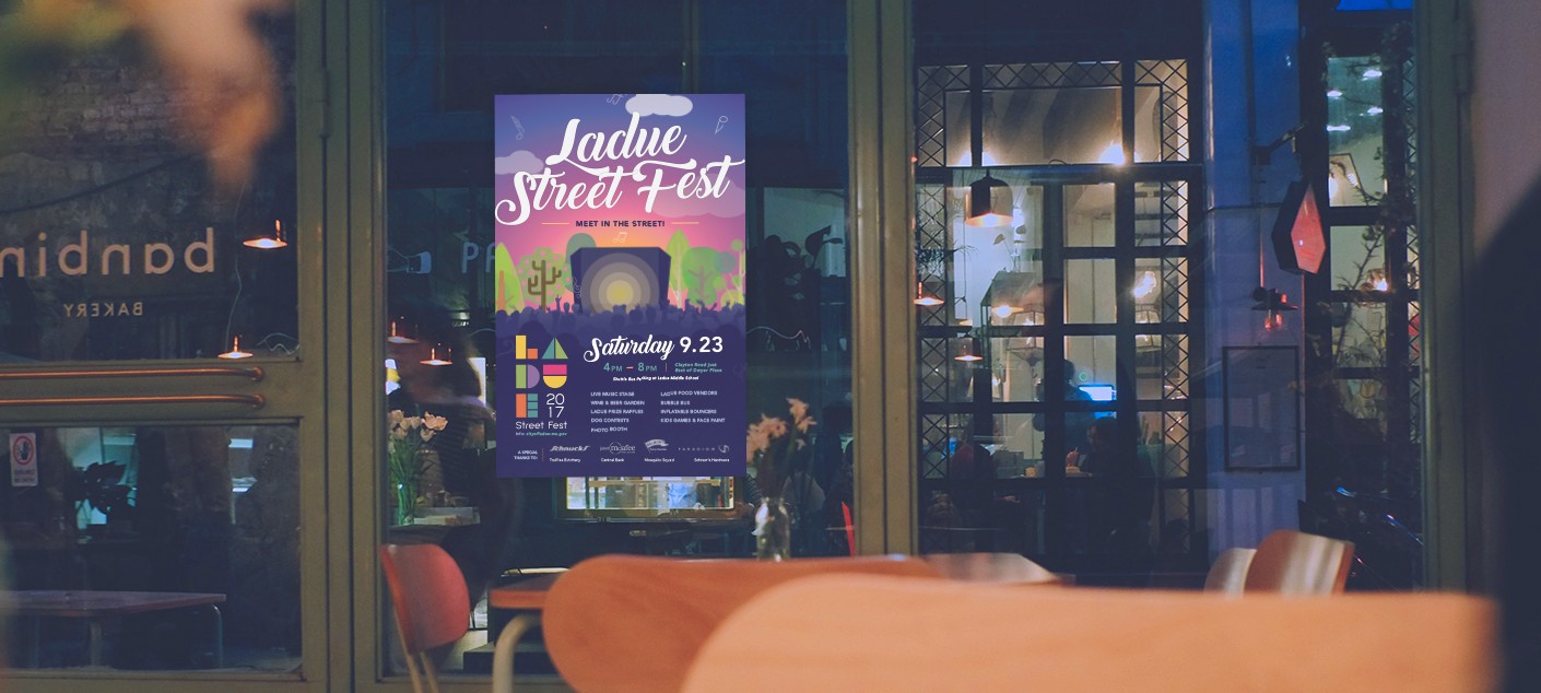 The final designed and printed poster for the Ladue Street Fest, hanging inside a local business to promote the event.