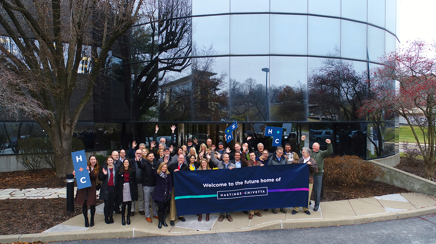 The Hastings + Chivetta team stands outside of their new office location.