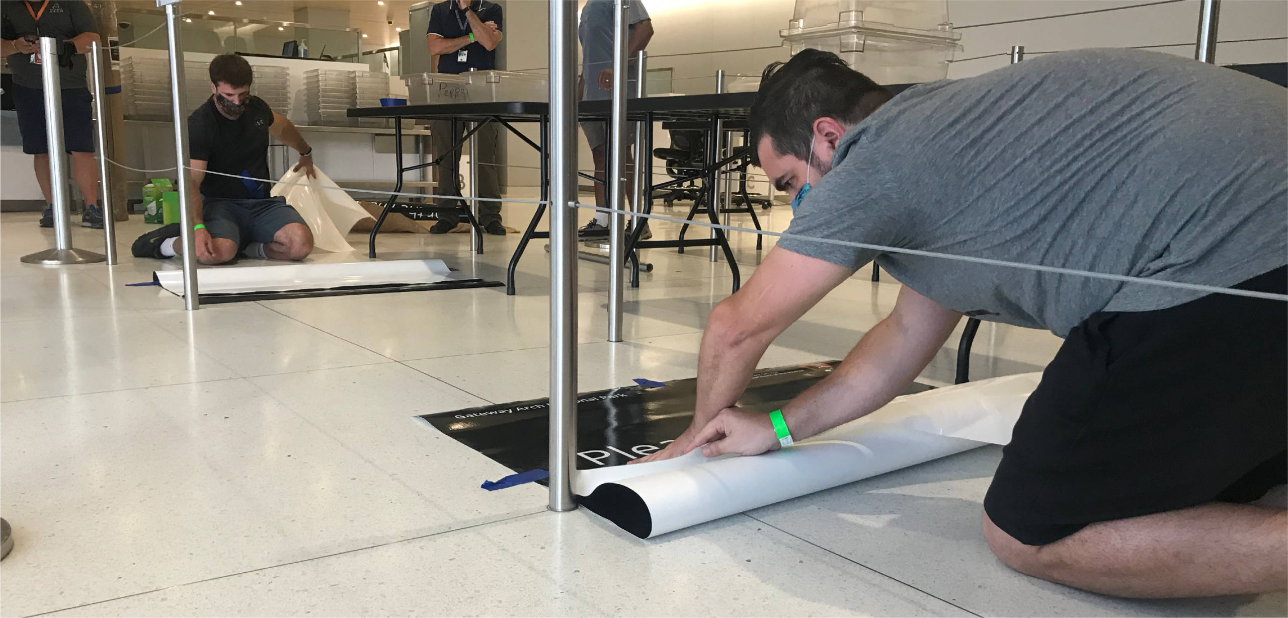 Installation of floor marker graphics for wayfinding.