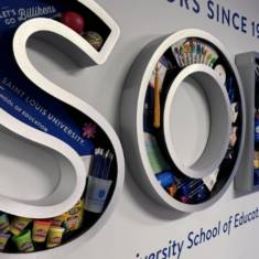 3D rendering of the letters SOE with school supplies inside the letters.