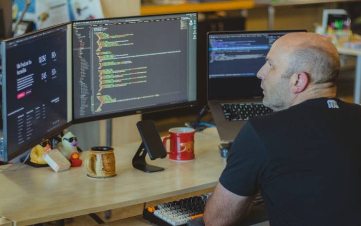 web developer looking at code on his computer