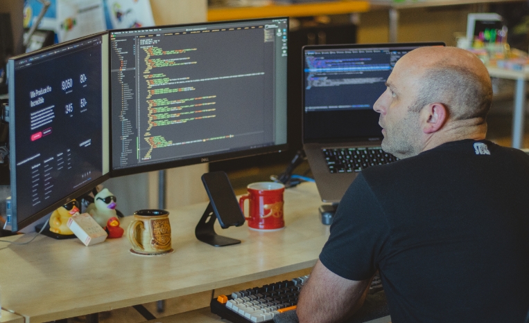 web developer looking at code on his computer