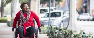 woman in wheelchair on the sidewalk