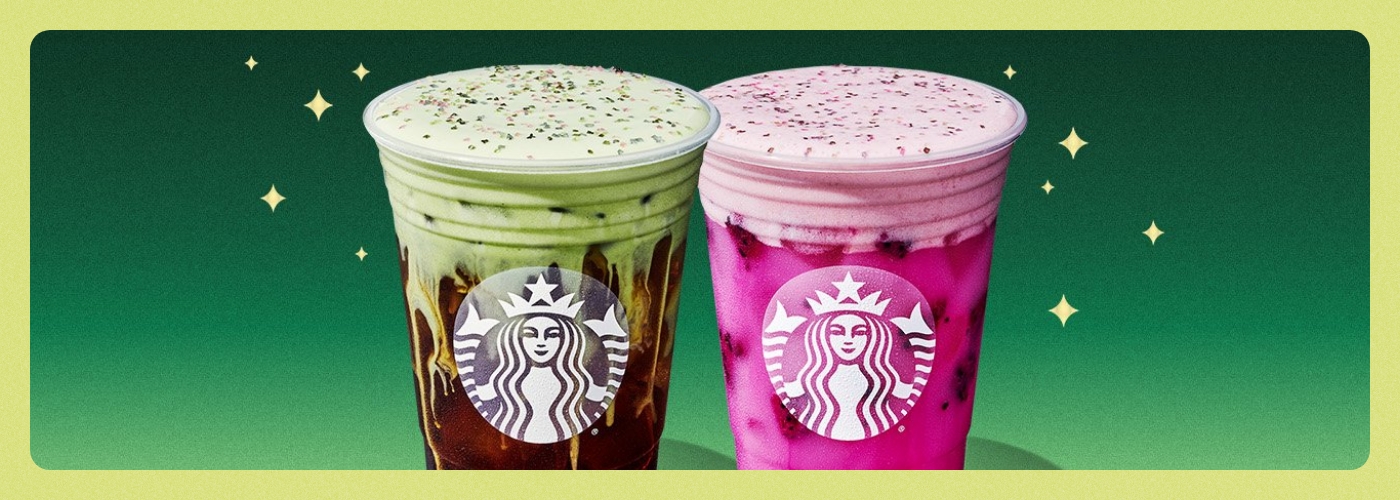 Two coffees from Starbucks, one colored green and one colored pink. 