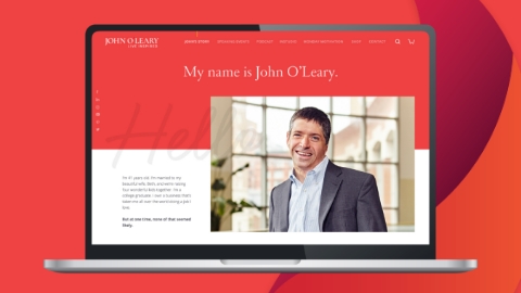 Laptop displaying website on red background.